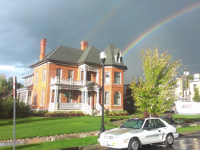 Historic John George Moroni Barnes House on Center Street in Kaysville, Utah, under a rainbow