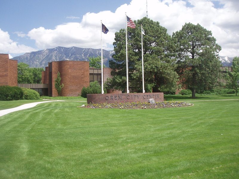 Orem City Center lawn, sign, and flags with Mount Timpanogos beyond, Orem, Utah