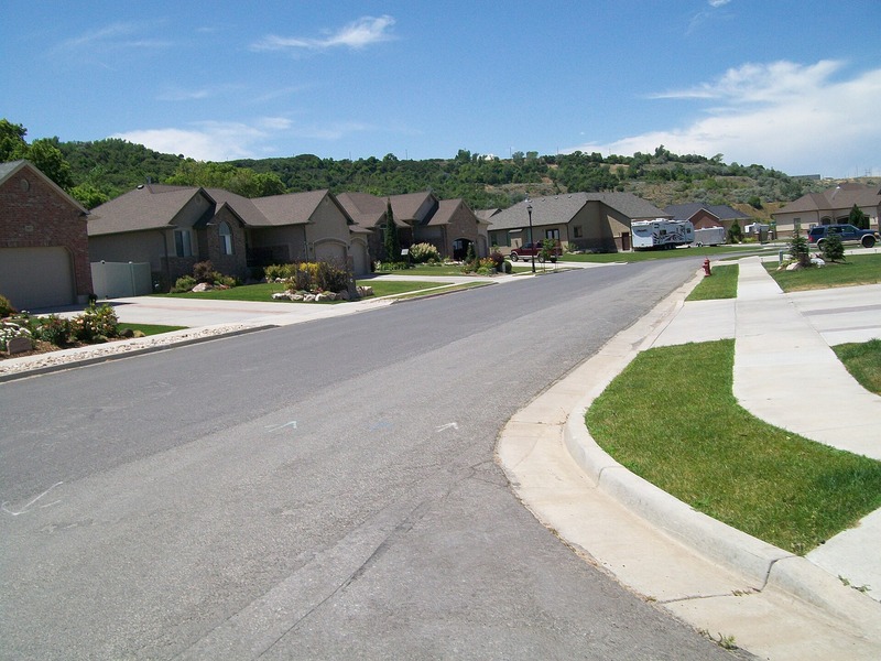 Neighborhood street with homes and the Wasatch Mountains in South Weber, Utah